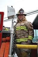 Ashley Jenkins dressed in firefighter gear