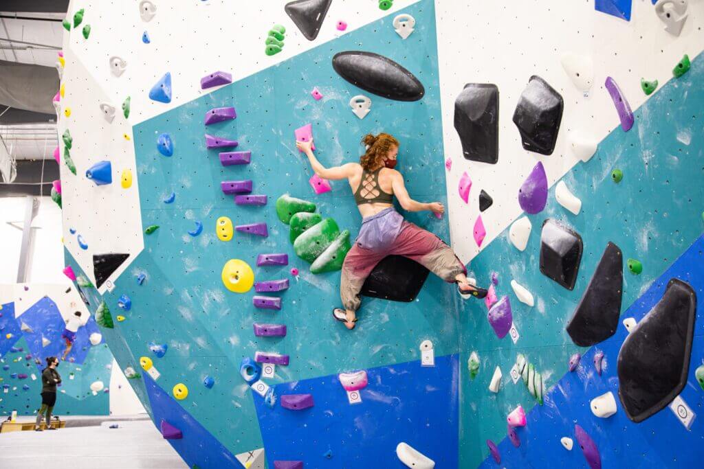 Person climbs wall at Gritstone Climbing + Fitness. 