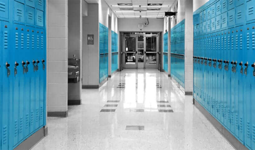 looking down a school hallway lined with blue lockers