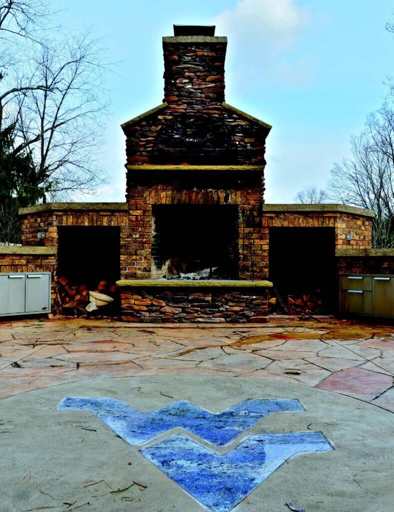 Huggins outdoor fire place and WVU themed patio. 