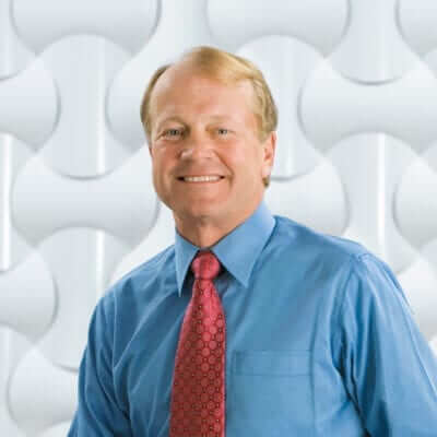 John Chambers smiling for the camera.