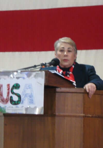 Anne Montague making a speech at a podium