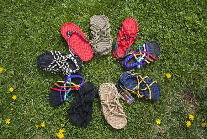 Hand-made sandals displayed in a circle on grass